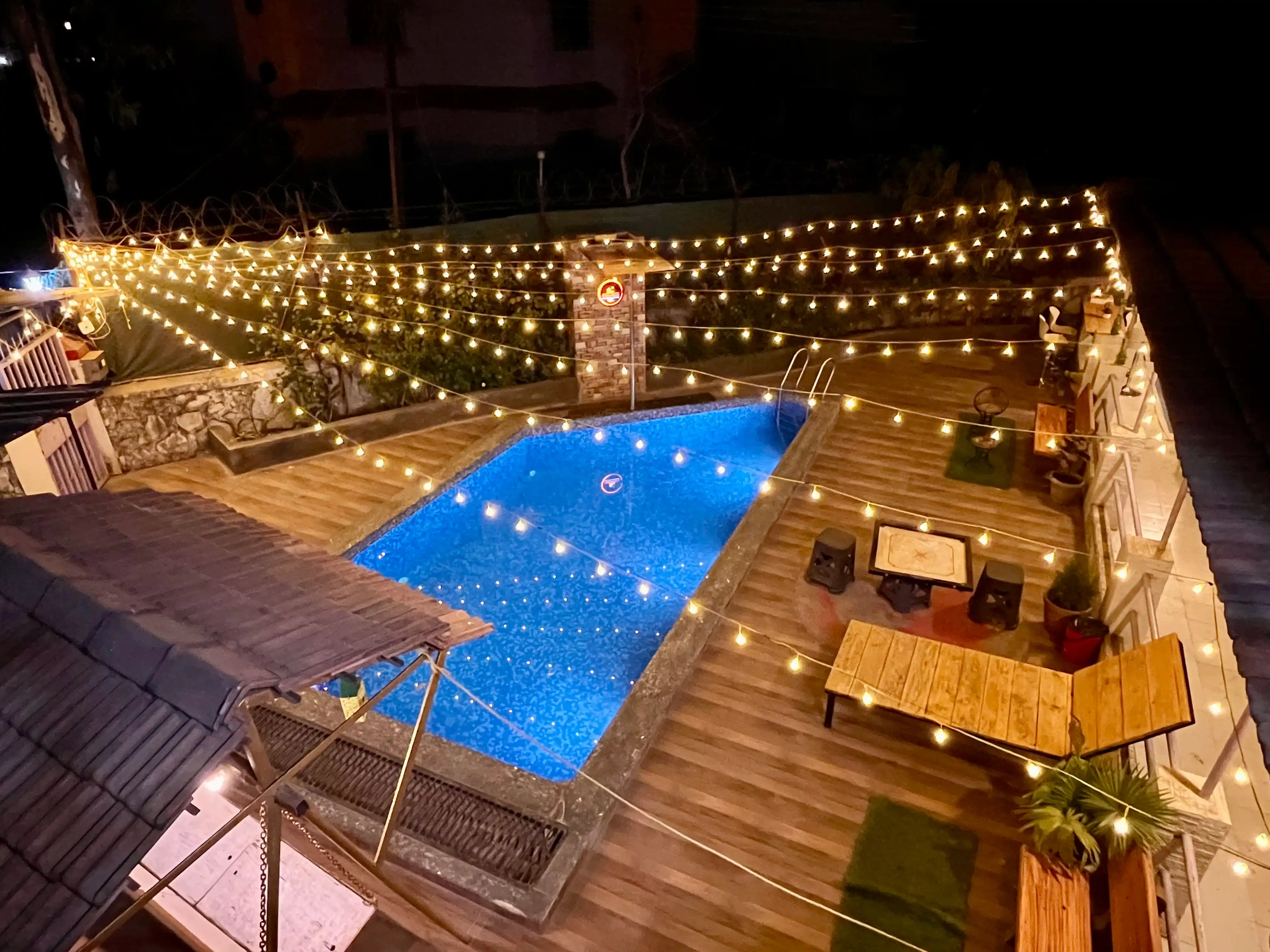 A serene nighttime view of the private pool at Govind Villa, enhanced by elegant warm lighting, offering a perfect blend of luxury and relaxation.