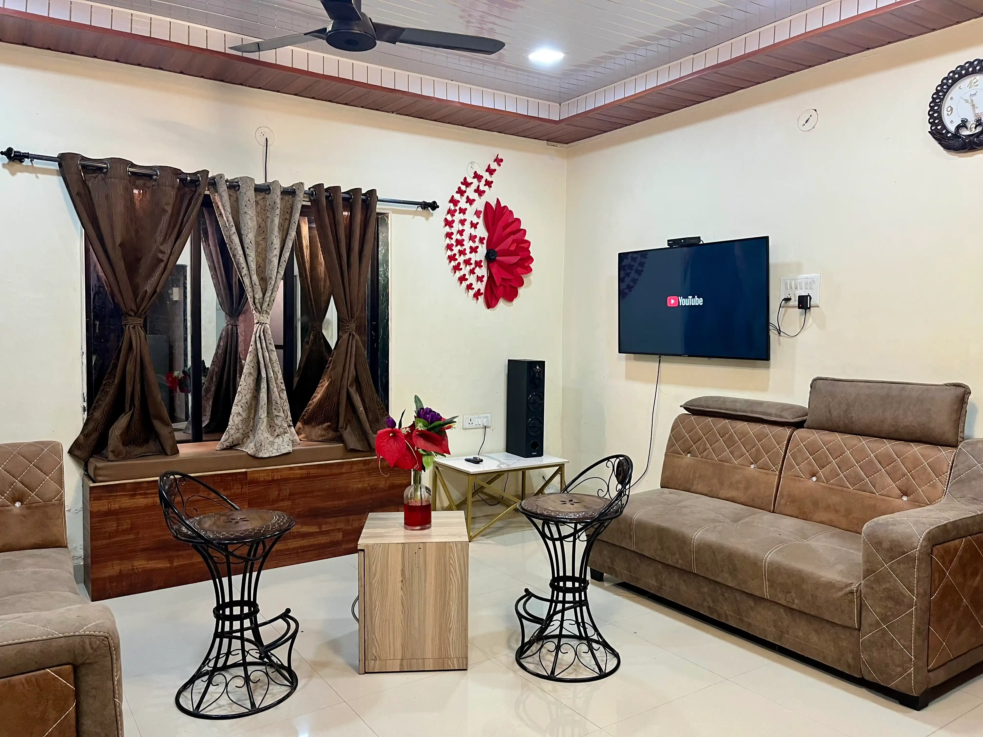 Spacious living area at Govind Villa, featuring modern furniture, a cozy ambiance, and large windows with scenic views.